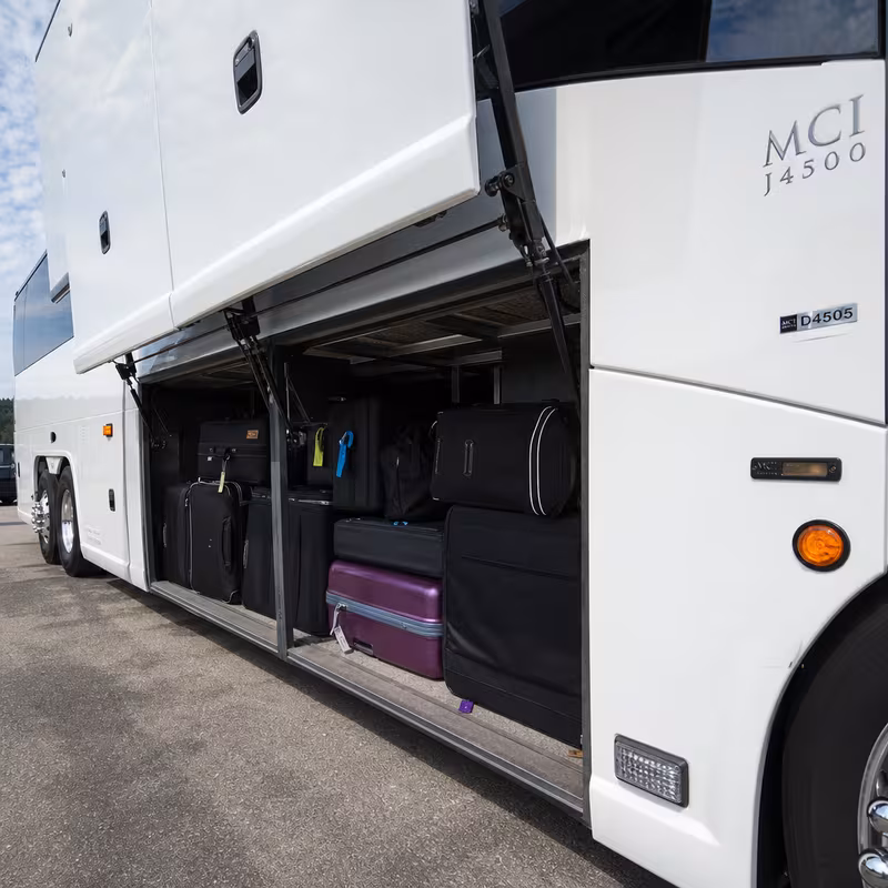 Party bus interior with wraparound leather seating and LED lighting in Stockton