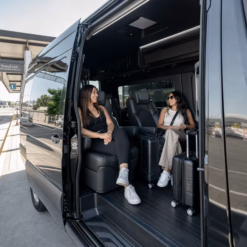 Passengers loading luggage while boarding an Stockton group shuttle