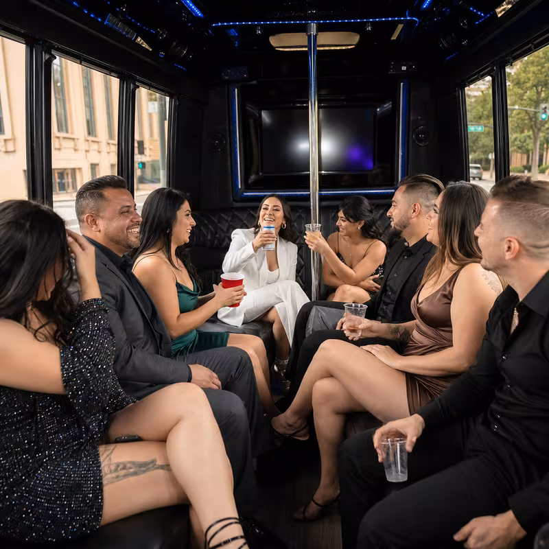 Party bus interior with wraparound leather seating and LED lighting in Stockton