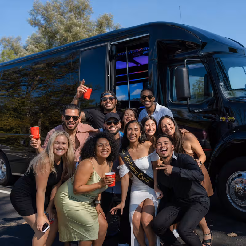 Group boarding a white charter bus for Birthday Transportation transportation in Stockton