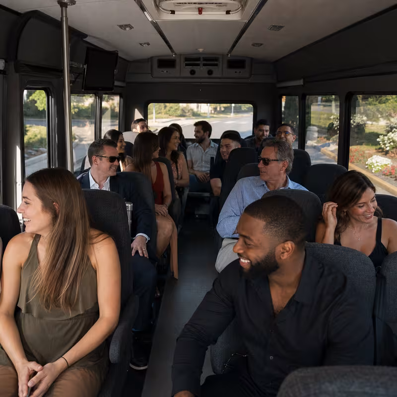 Group boarding a white charter bus for Private Event Transportation transportation in Stockton