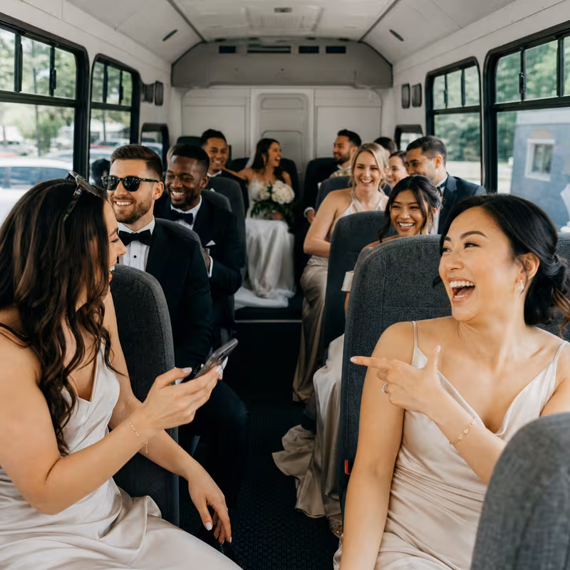 Group boarding a white charter bus for Wedding Transportation transportation in Stockton