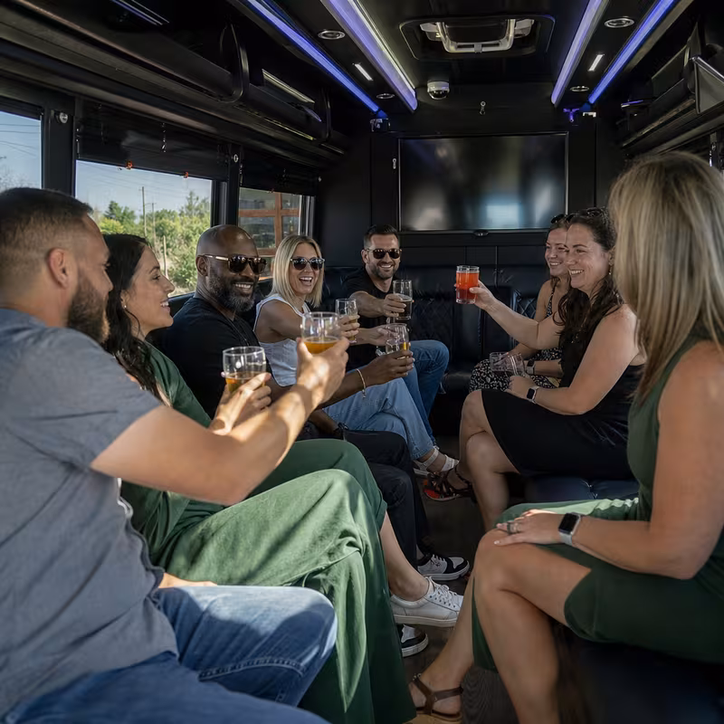 Group boarding a white charter bus for Winery & Brewery Tour Transportation transportation in Stockton